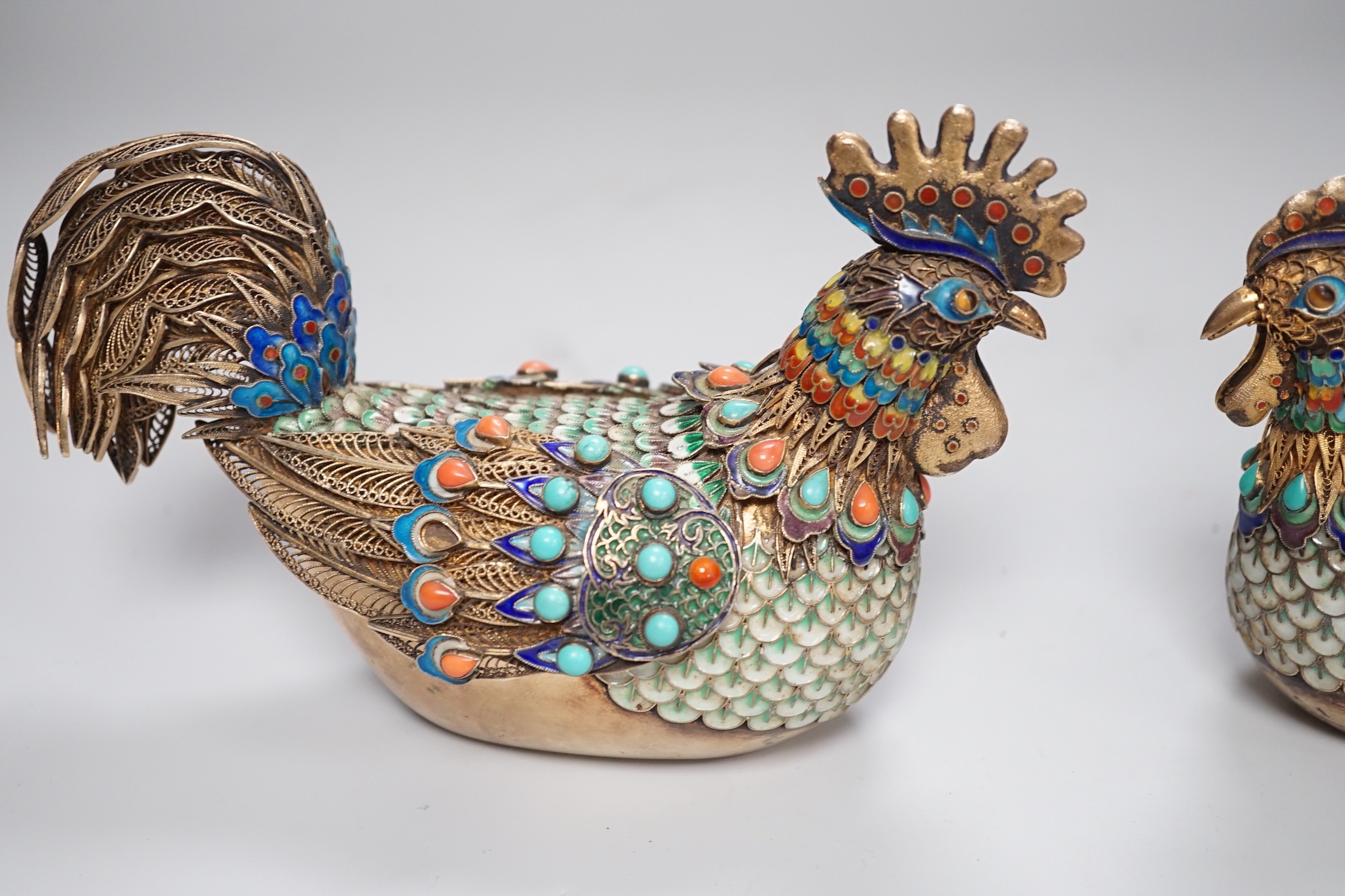 A pair of cased Chinese enamelled gilt white metal roosters with turquoise and coral mounts 14cms wide